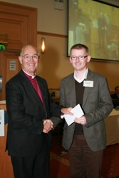 Jonny Campbell-Smyth, St Patrick's, Coleraine, receives the prize for best parish magazine from the Archbishop of Armagh.